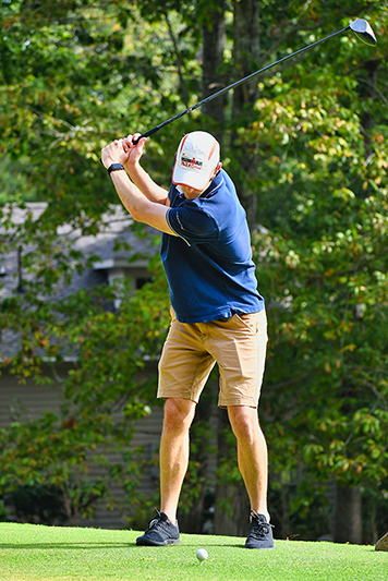 golfer doing a practice swing on the tee