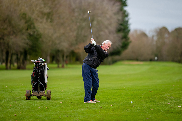 golfer with electric trolley on fairway